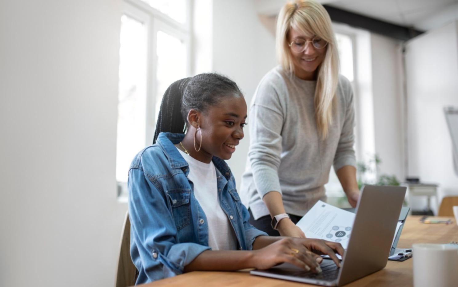 Collaborative workspace with students reviewing financial documents